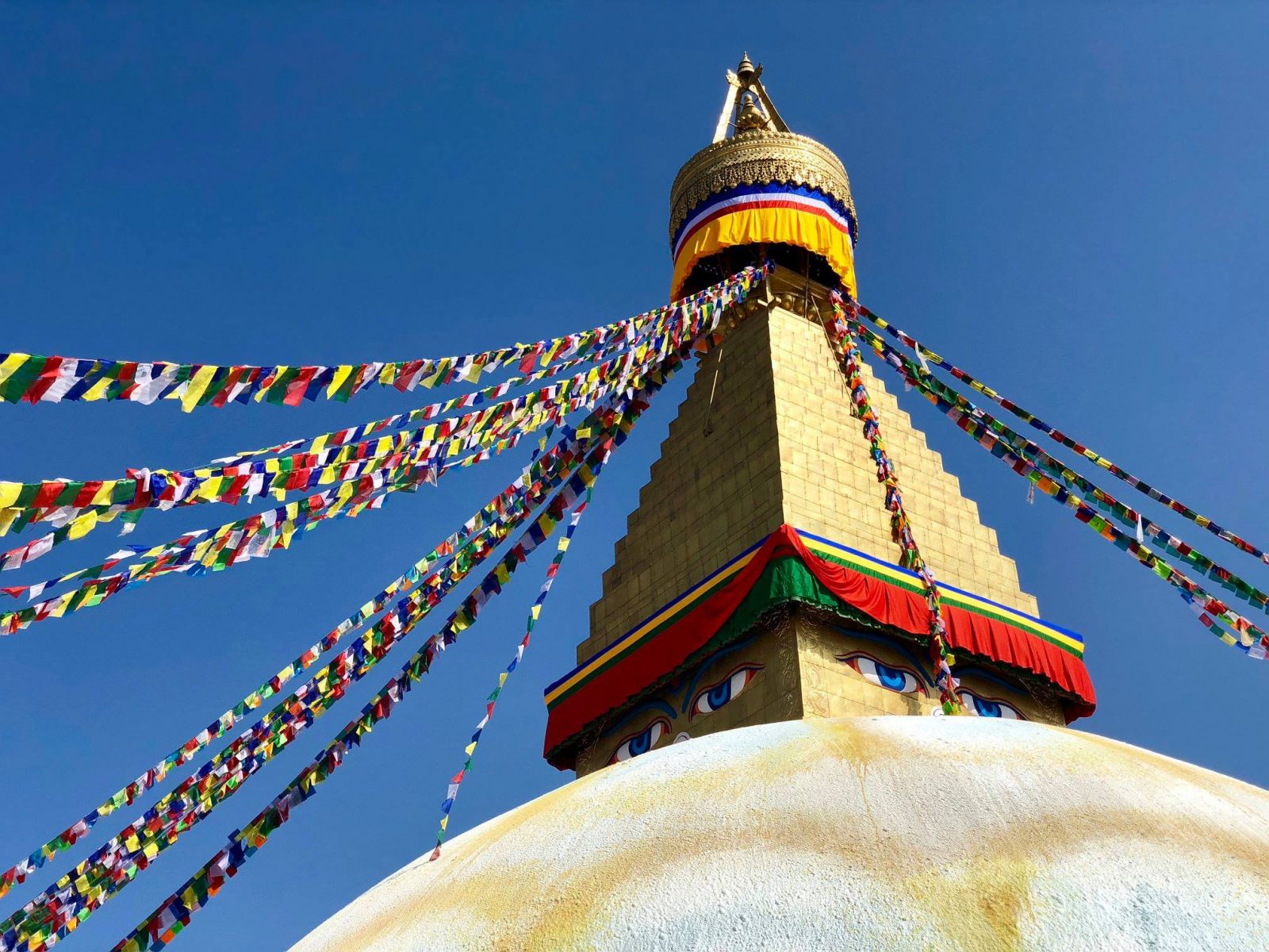 The Boudhanath Stupa, down the hill from Kopan Monastery, in Kathmandu. Each year we begin the Nepal & India pilgrimage at Kopan and also spend time at Boudha, doing practices as advised by Lama Zopa Rinpoche. Photo: Lauren Ross, Nepal & India Pilgrimage 2018.